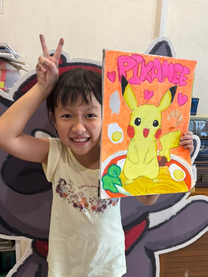 Student showing orange bear artwork