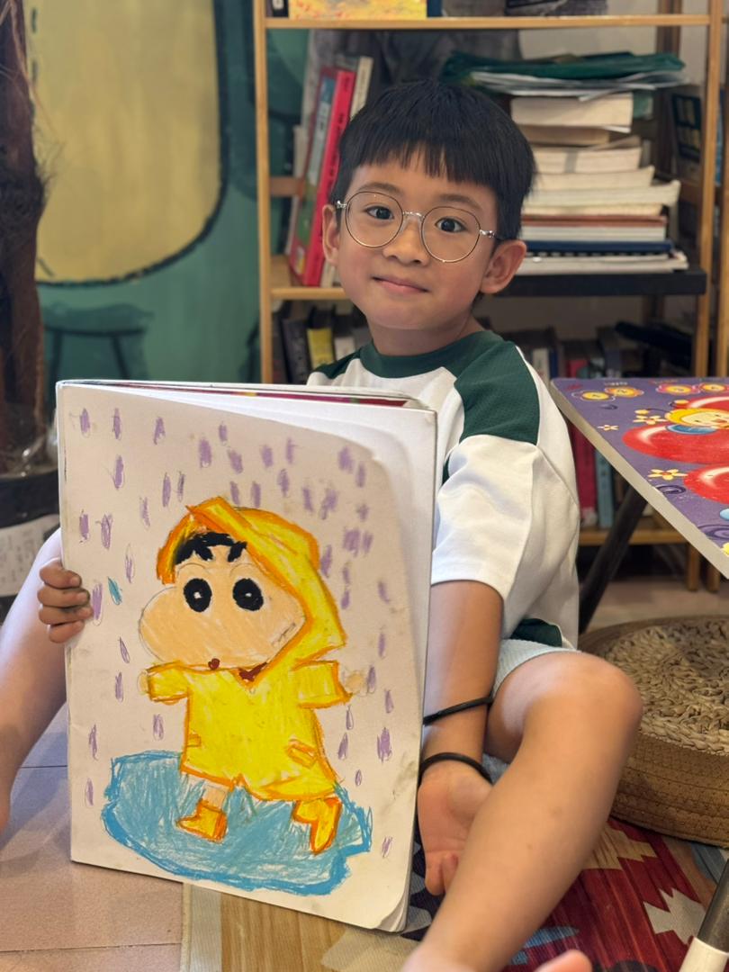 Student showing character artwork
