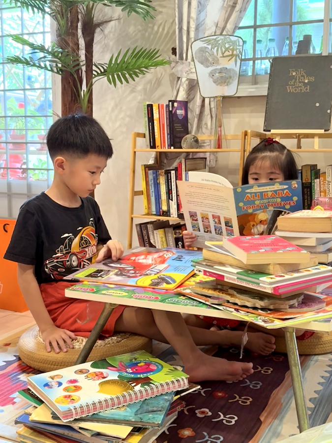 Children reading together in a cozy corner